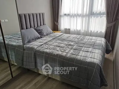 Cozy bedroom with modern decor and large window for natural light