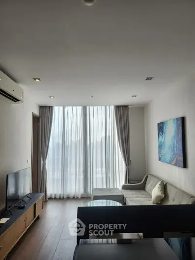 Modern living room with large windows and stylish decor