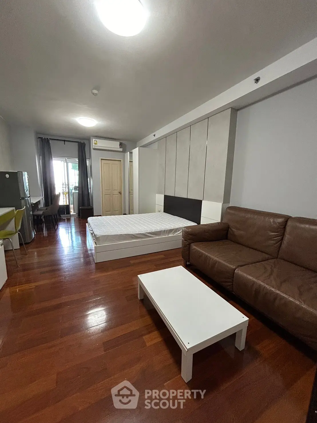 Spacious studio apartment with modern furnishings and hardwood floors