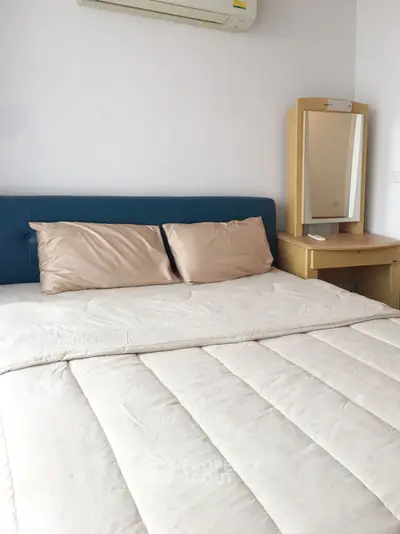 Cozy bedroom with modern air conditioning and stylish vanity set, perfect for relaxation and comfort.