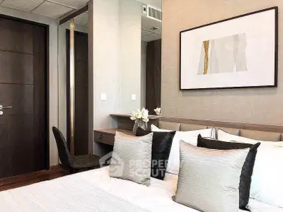 Elegant bedroom with modern decor and stylish artwork, featuring plush pillows and a cozy atmosphere.