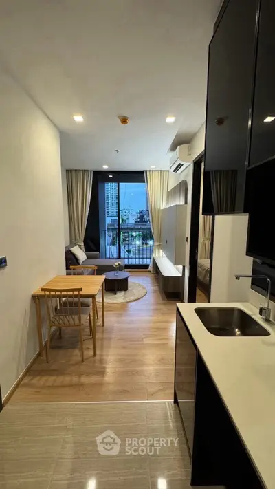 Modern open-layout living room with balcony view in a stylish apartment