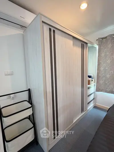 Modern bedroom with sleek wardrobe and stylish decor