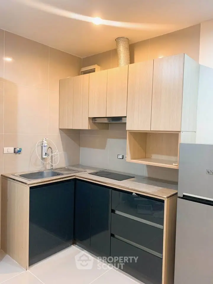 Modern kitchen with sleek cabinetry and built-in appliances in a stylish apartment.