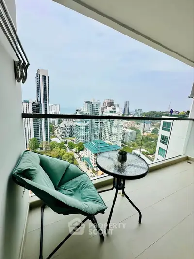 Stunning high-rise balcony with breathtaking cityscape view and cozy seating area.