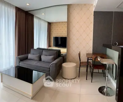 Modern living room with stylish decor and natural light, featuring a cozy sofa and sleek coffee table.