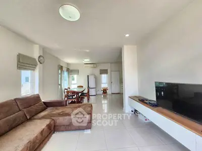 Spacious living room with modern furniture and natural light in a contemporary home.