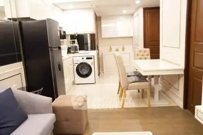Modern kitchen and dining area with sleek appliances and elegant decor