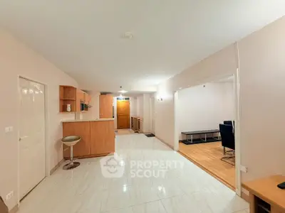 Spacious open-plan living area with modern kitchen and stylish flooring.