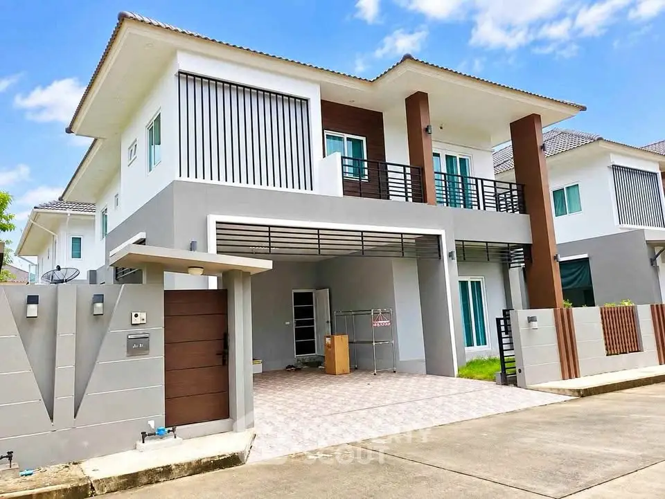 Modern two-story house with spacious driveway and contemporary design in a suburban neighborhood.