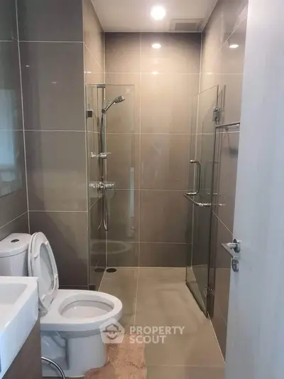 Modern bathroom with sleek glass shower and contemporary fixtures.