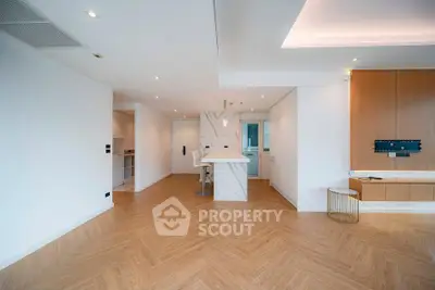 Spacious modern living room with open kitchen and elegant wooden flooring
