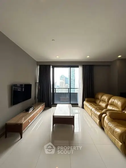 Spacious modern living room with leather sofa and city view balcony