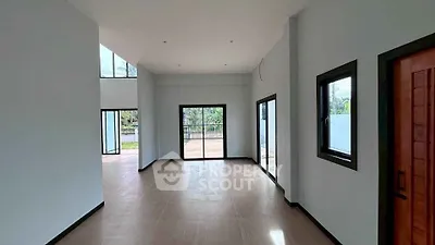 Spacious modern living room with large windows and natural light
