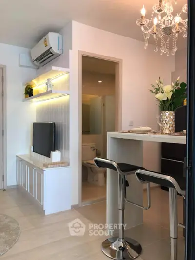 Modern living room with open kitchen and elegant decor in a stylish apartment.