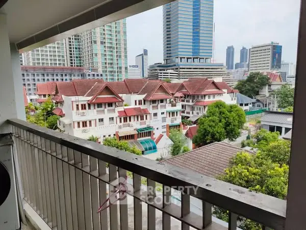 Stunning urban view from a balcony overlooking city skyline and residential area.