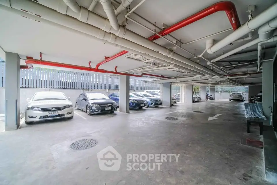 Spacious covered parking area with multiple cars and clear pathways.