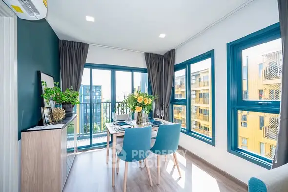 Bright dining area with modern decor and large windows overlooking cityscape.