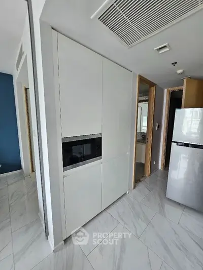 Modern kitchen with sleek cabinetry and built-in appliances in a stylish apartment.