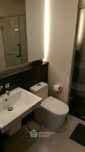 Modern bathroom with sleek fixtures and glass shower enclosure