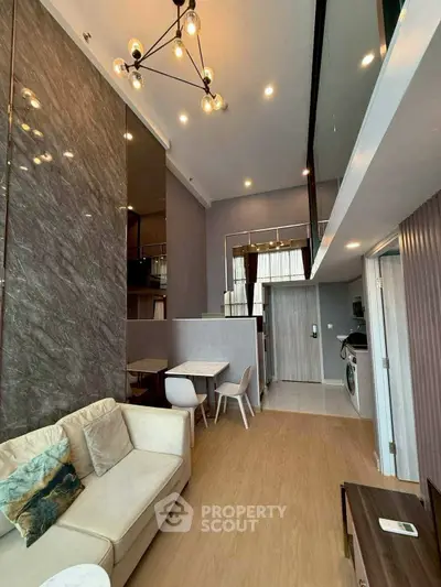 Modern loft-style living room with elegant lighting and open layout