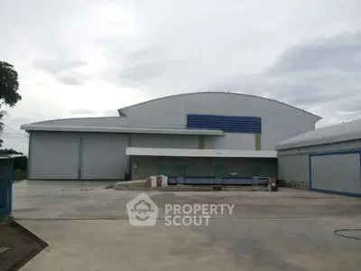 Spacious industrial warehouse exterior with ample loading area and modern design.