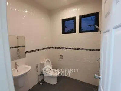 Modern bathroom with sleek white tiles and contemporary fixtures