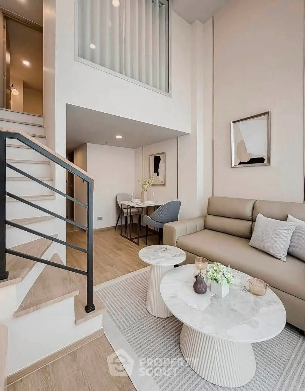 Modern duplex living room with elegant decor and staircase