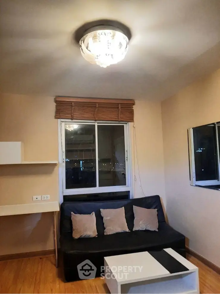 Cozy living room with modern lighting and comfortable seating, perfect for relaxation.