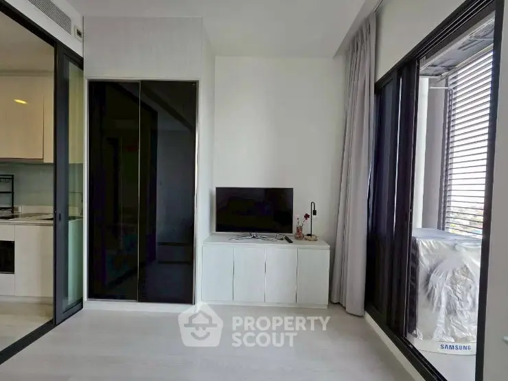 Modern living room with sleek design and large windows offering natural light.