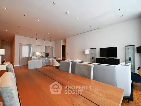 Spacious modern living room with open kitchen and elegant dining area.