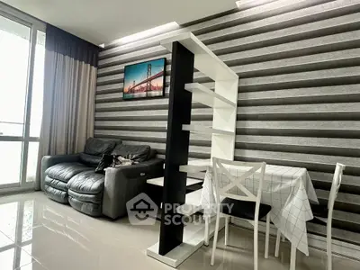 Modern living room with stylish decor and natural light, featuring a cozy sofa and dining area.
