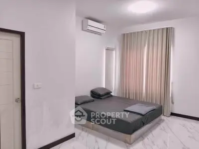 Modern minimalist bedroom with air conditioning and natural light