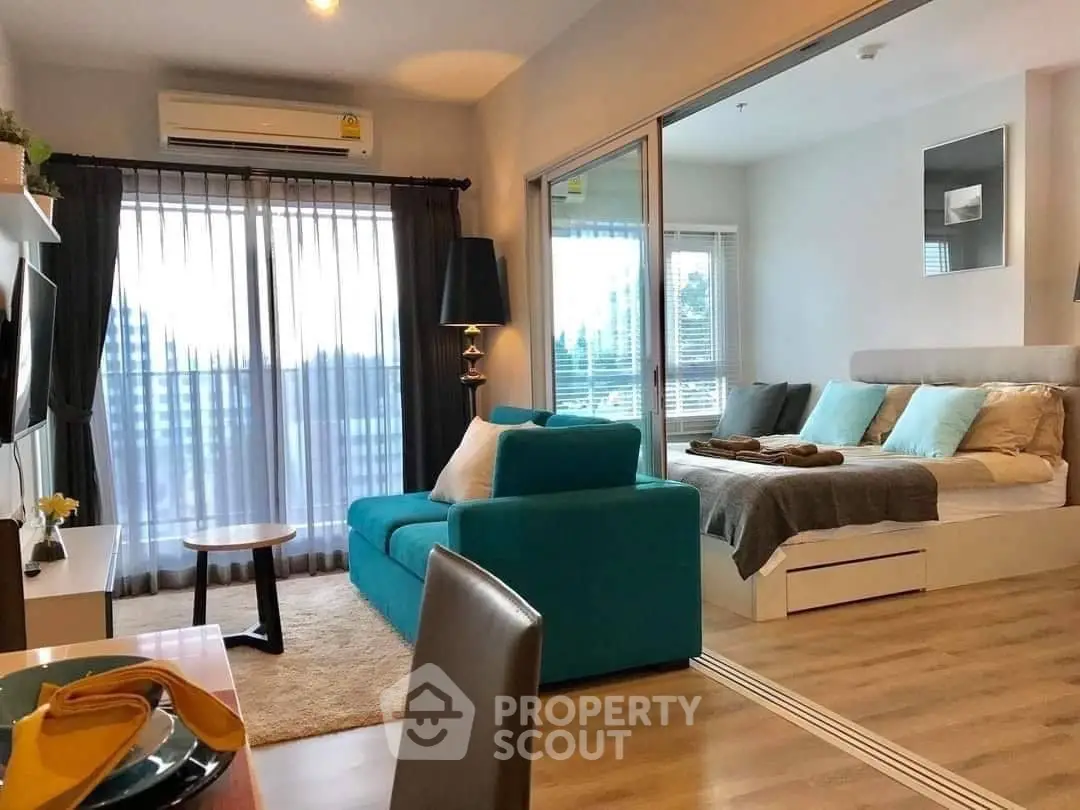 Spacious living room with modern furnishings, large windows, and abundant natural light, perfect for comfortable urban living.