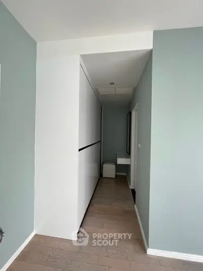 Modern hallway with sleek storage and minimalist design in a contemporary home.