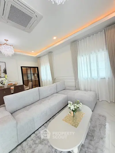 Luxurious living room with elegant decor and plush seating in a modern home.
