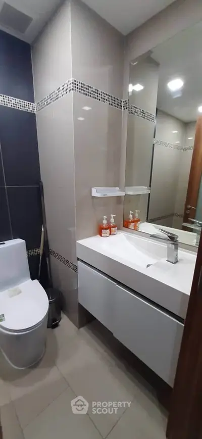 Modern bathroom with sleek fixtures and stylish tile design, perfect for contemporary living.