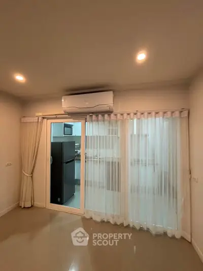 Modern living room with sliding glass doors and air conditioning unit