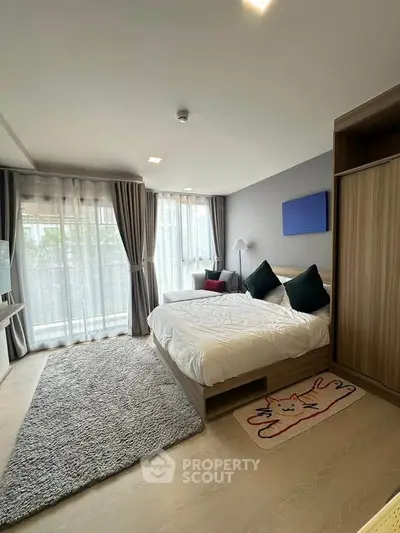 Spacious modern bedroom with large windows and stylish decor