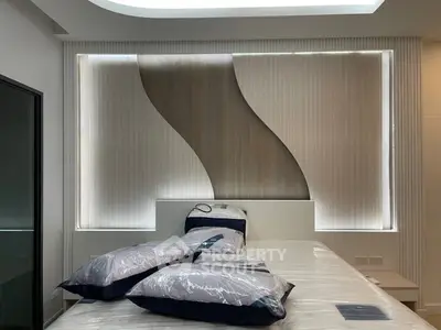 Modern bedroom with stylish wall design and cozy bedding