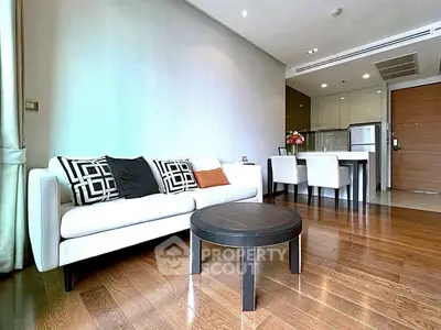Modern living room with elegant decor and open kitchen layout in a stylish apartment.
