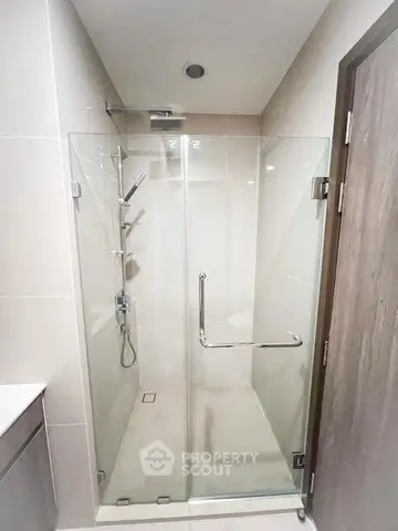 Modern bathroom with glass shower enclosure and sleek fixtures