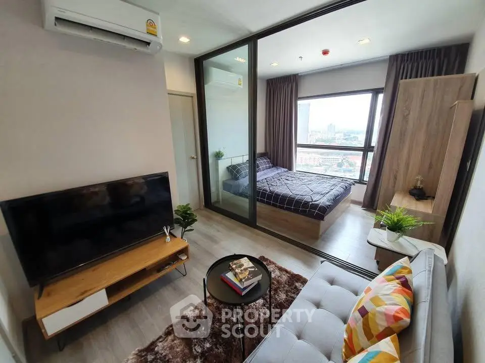 Modern apartment with cozy living room and bedroom, featuring stylish decor and city view.