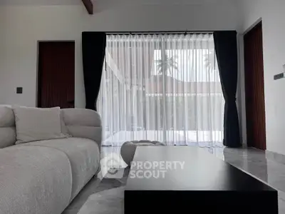 Elegant living room with modern sofa and large window view