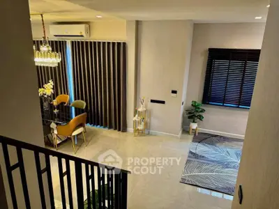 Elegant modern dining area with stylish decor and large windows in a contemporary home.