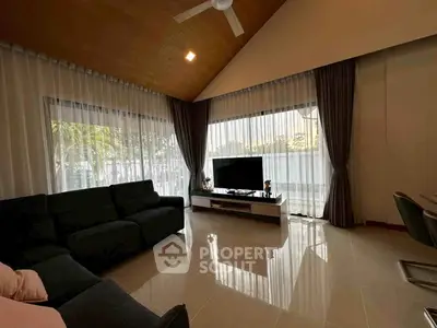Spacious living room with modern decor and large windows offering natural light.