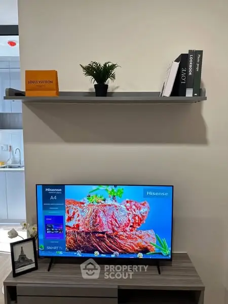 Modern living room with sleek TV setup and stylish shelf decor