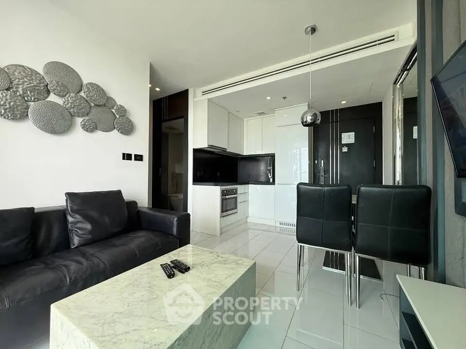 Modern living room with sleek kitchen and marble coffee table in luxury apartment.