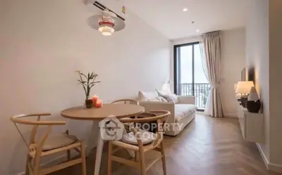 Modern living room with elegant decor and large window offering natural light and city view.