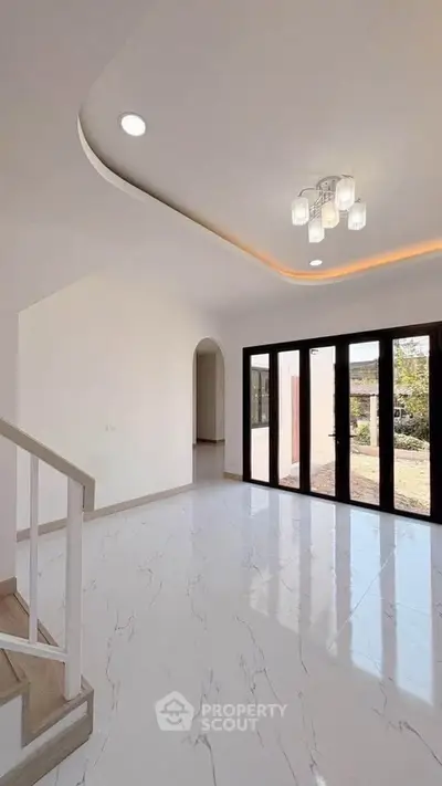 Elegant modern living room with large windows and stylish lighting